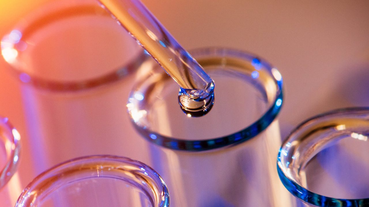 A drop of liquid being dropped into a test tube