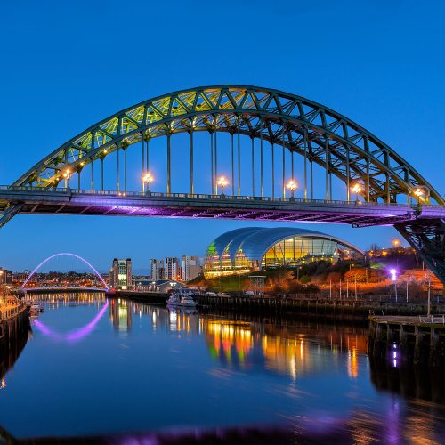 Image of the Tyne Bridge lit up at night.