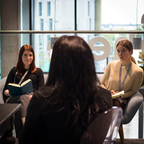 Three women having a conversation at an event